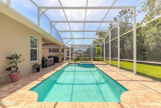 3418 Leonardo Ln, New Smyrna Beach, FL 32168 - view of swimming pool with a patio area, glass enclosure, a pool with connected hot tub, and a yard