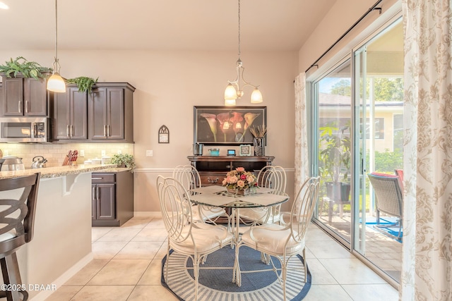 3418 Leonardo Ln, New Smyrna Beach, FL 32168 - dining space with light tile patterned floors