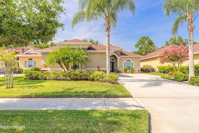 3418 Leonardo Ln, New Smyrna Beach, FL 32168 - mediterranean / spanish home featuring stucco siding, concrete driveway, and a front yard