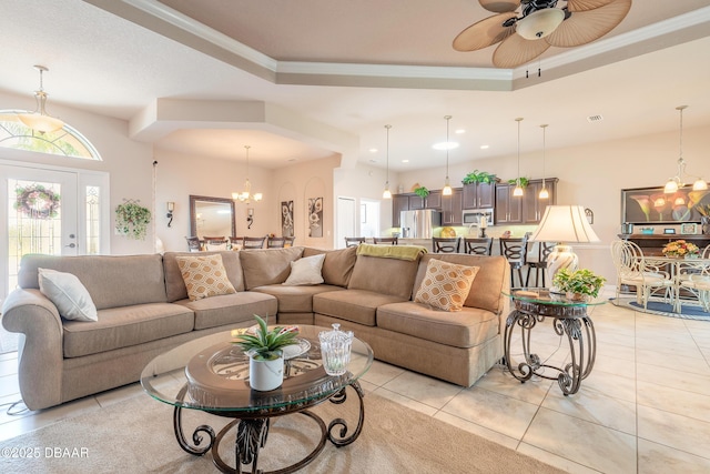 3418 Leonardo Ln, New Smyrna Beach, FL 32168 - living area featuring a raised ceiling, a chandelier, crown molding, recessed lighting, and light tile patterned floors