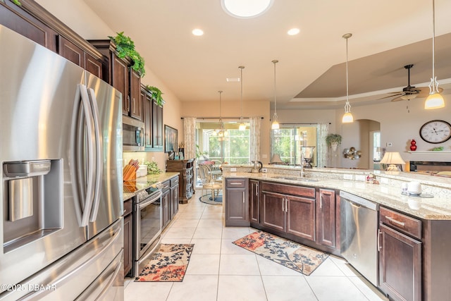 3418 Leonardo Ln, New Smyrna Beach, FL 32168 - kitchen with stainless steel appliances, ceiling fan, light tile patterned floors, dark brown cabinetry, and recessed lighting