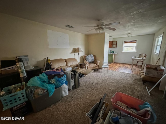 carpeted living room featuring ceiling fan