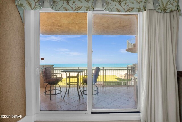 doorway featuring a wealth of natural light and a water view