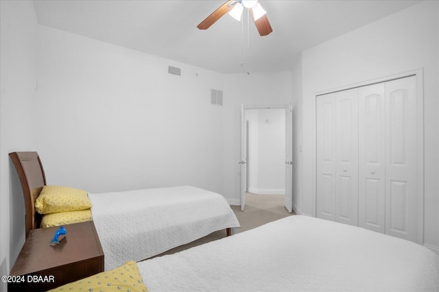 carpeted bedroom featuring ceiling fan and a closet