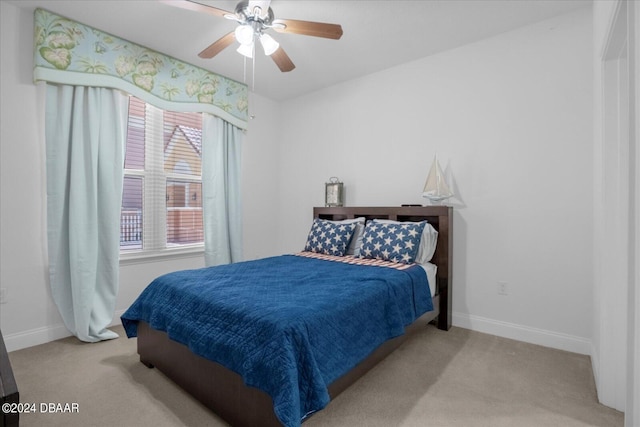 bedroom with ceiling fan and light colored carpet