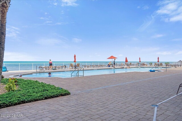 view of pool featuring a water view