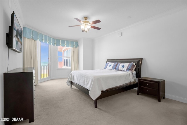 bedroom featuring ceiling fan, crown molding, and light colored carpet