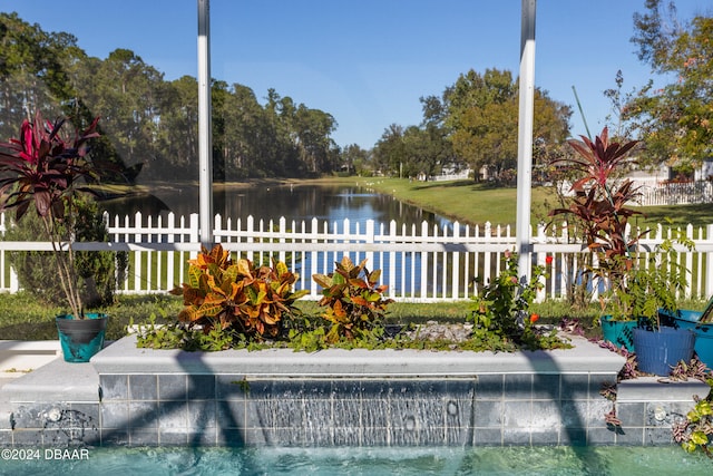 view of swimming pool with a water view