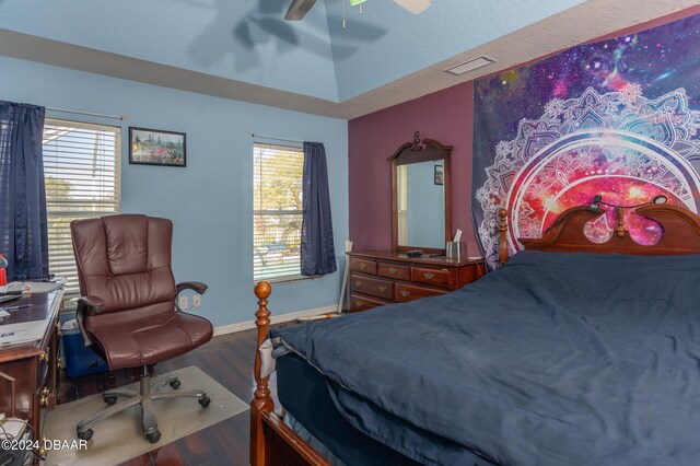 bedroom with multiple windows, ceiling fan, hardwood / wood-style floors, and a textured ceiling