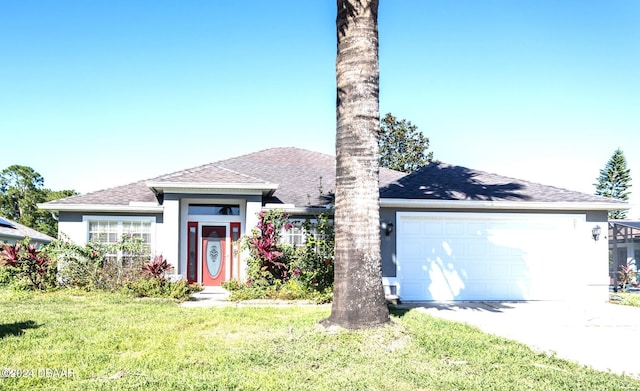 view of front of home with a front yard and a garage