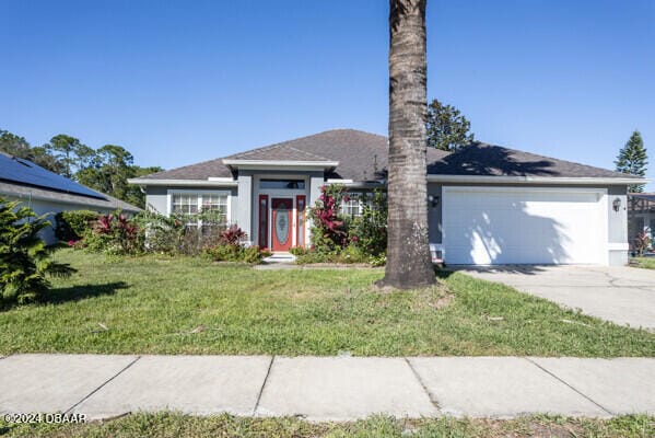 view of front facade featuring a garage and a front lawn