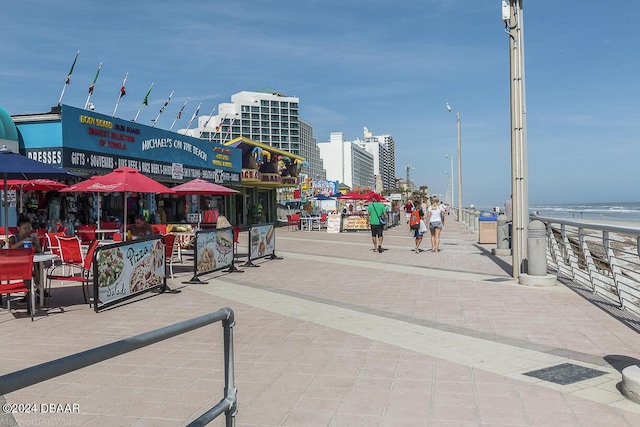 view of property's community featuring a water view and a view of the beach