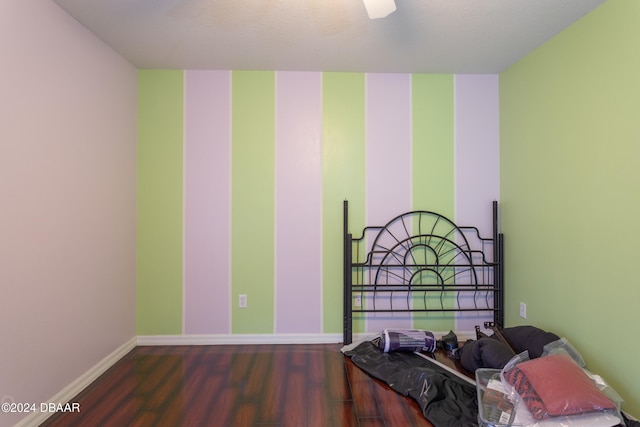 bedroom featuring ceiling fan and dark wood-type flooring