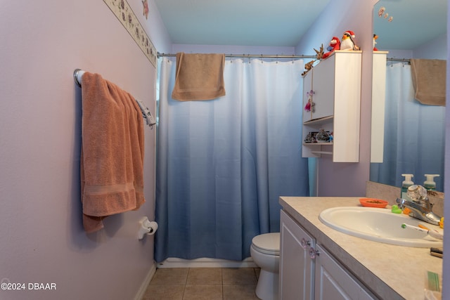 bathroom with tile patterned flooring, vanity, and toilet