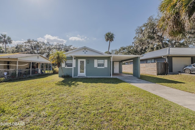 ranch-style home with a front yard and a carport