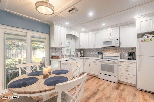 kitchen featuring white cabinets, light hardwood / wood-style flooring, sink, and white appliances