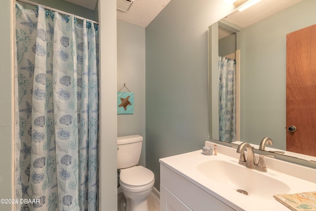 bathroom featuring toilet, vanity, a textured ceiling, and a shower with shower curtain