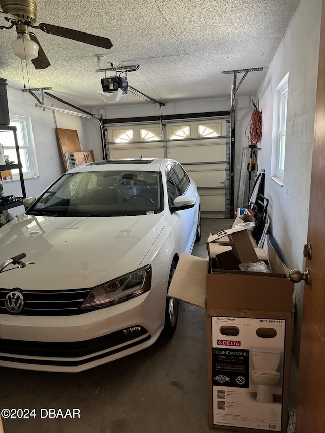 garage featuring a garage door opener and ceiling fan