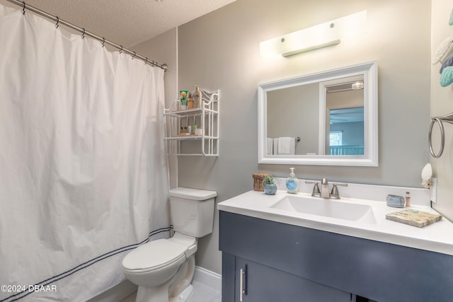 bathroom featuring toilet, vanity, a textured ceiling, and curtained shower