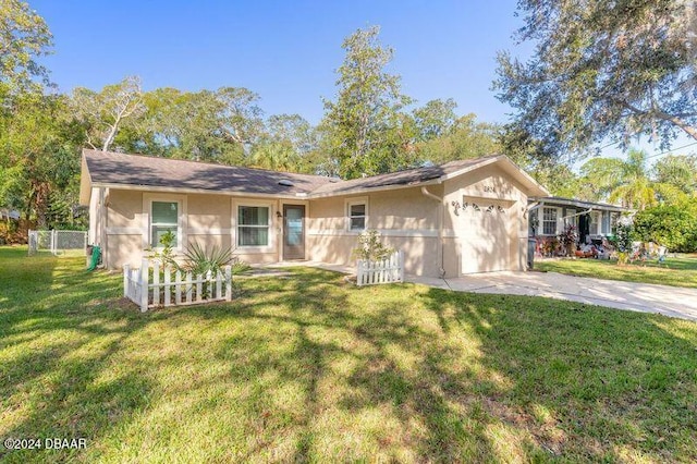 ranch-style home with a garage and a front yard