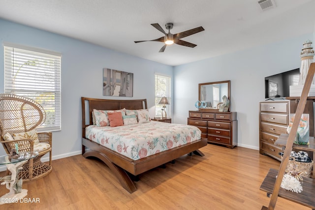 bedroom with ceiling fan and light hardwood / wood-style flooring