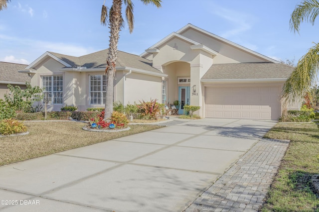 view of front facade with a garage and a front lawn