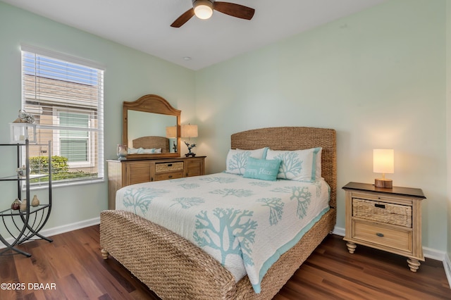 bedroom with multiple windows, ceiling fan, and dark hardwood / wood-style flooring