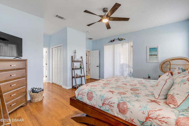 bedroom featuring ceiling fan, a closet, and light wood-type flooring