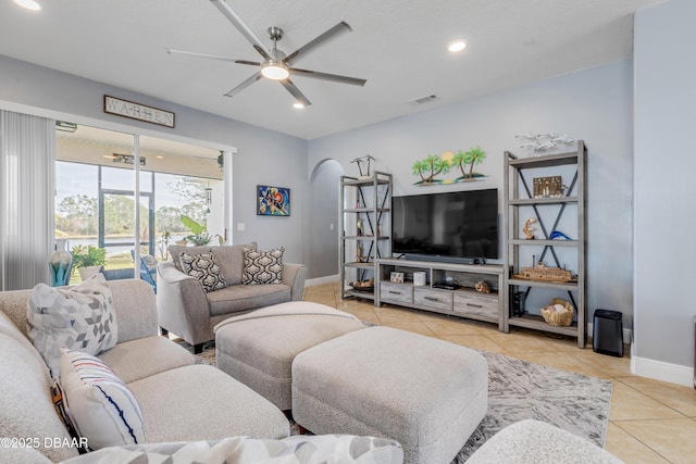 living room featuring light tile patterned flooring and ceiling fan