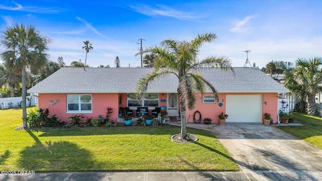 single story home with a garage and a front lawn