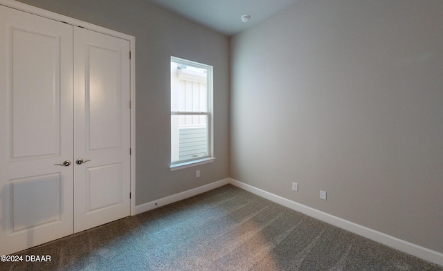 unfurnished bedroom with carpet and a closet