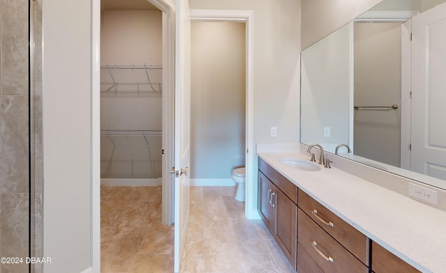 bathroom with toilet and vanity