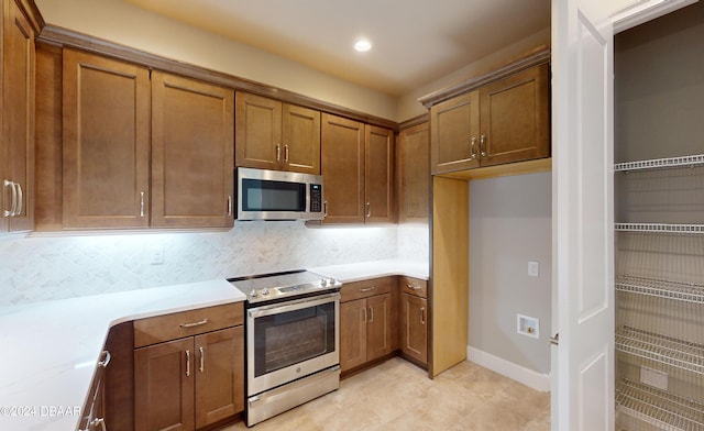 kitchen with stainless steel appliances and tasteful backsplash