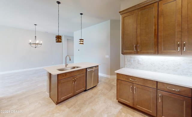 kitchen with decorative light fixtures, sink, an island with sink, decorative backsplash, and dishwasher