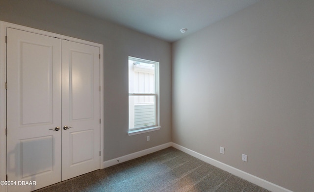 unfurnished bedroom with carpet and a closet