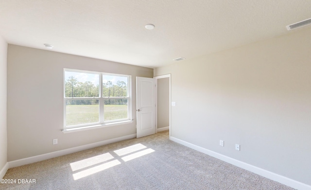 empty room featuring light carpet