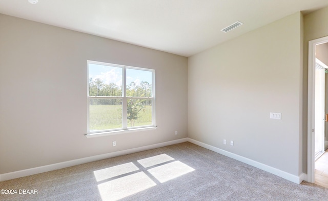 spare room with light colored carpet