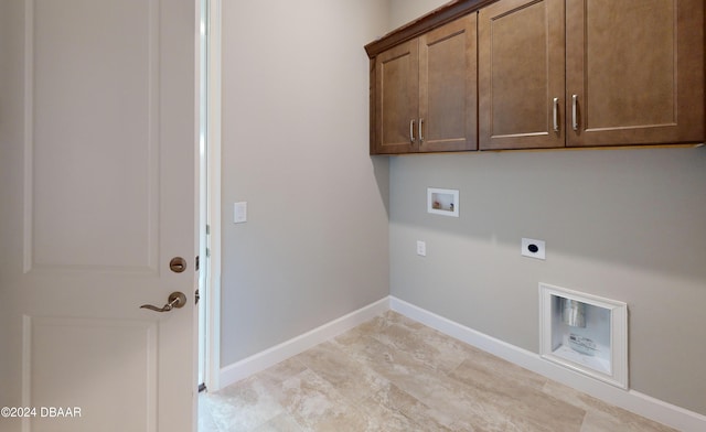 clothes washing area with washer hookup, cabinets, and hookup for an electric dryer