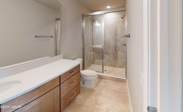 bathroom with vanity, tile patterned floors, toilet, and a shower with shower door