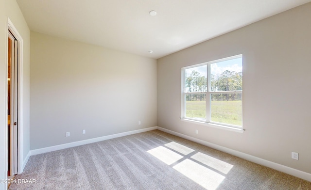 unfurnished room with light colored carpet