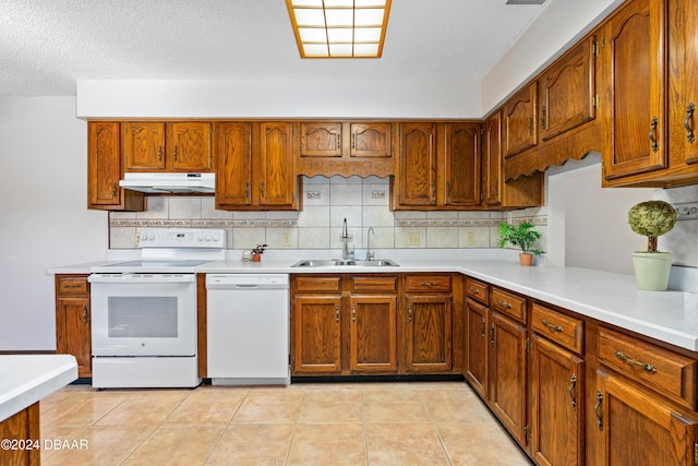 kitchen with a textured ceiling, light tile patterned flooring, white appliances, and sink