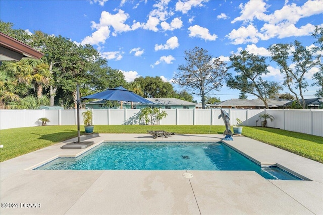 view of pool featuring a patio and a yard