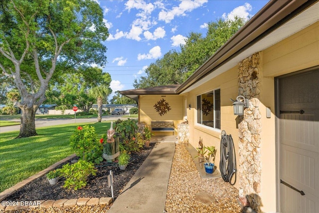 view of side of property featuring a garage and a lawn