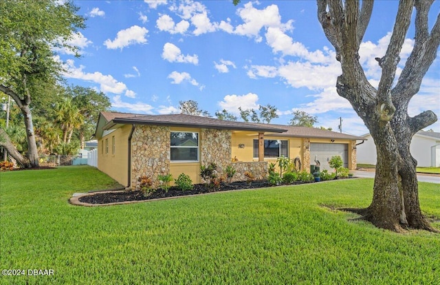 ranch-style home featuring a front lawn and a garage