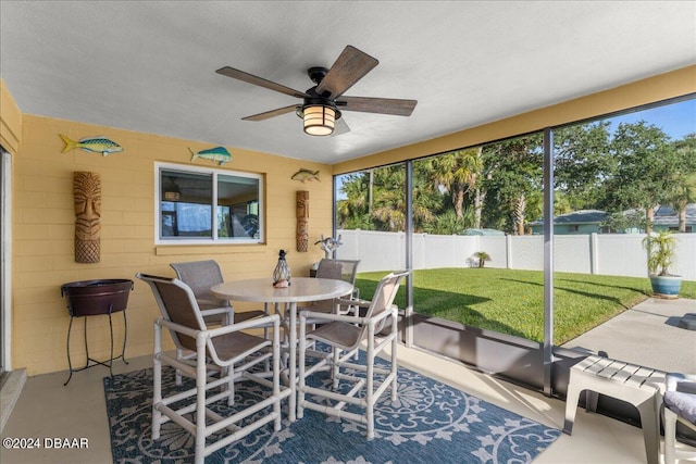 sunroom / solarium with ceiling fan and a healthy amount of sunlight