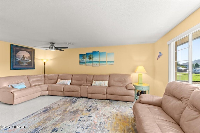 living room featuring a textured ceiling and ceiling fan