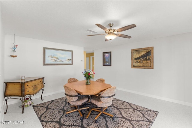 carpeted dining room featuring ceiling fan