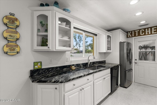 kitchen featuring sink, black dishwasher, stainless steel fridge, and white cabinets