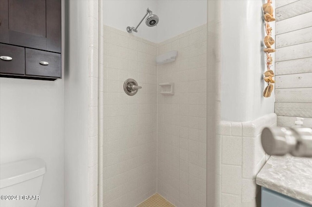 bathroom with tiled shower and toilet