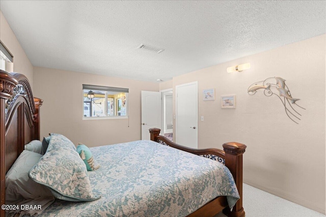 carpeted bedroom featuring a textured ceiling